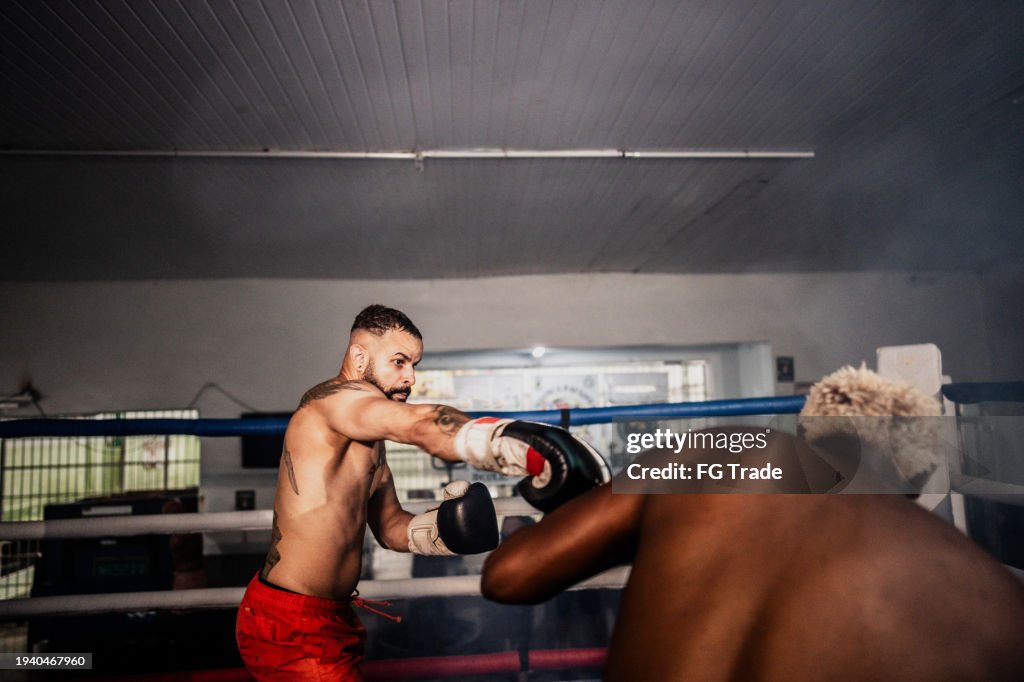 Boxer man fighting on a boxing ring