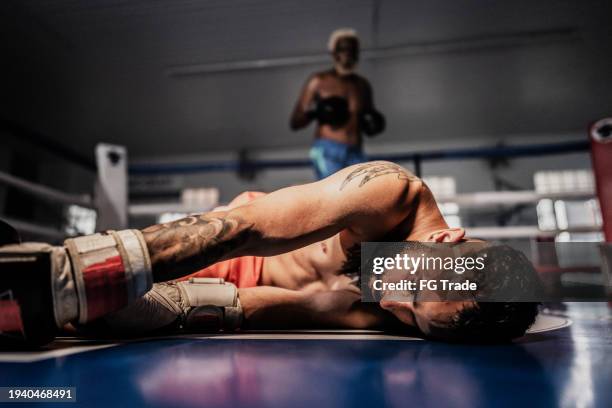 boxer man unconscious after be knocked out on a boxing ring - boxer knockout stock pictures, royalty-free photos & images