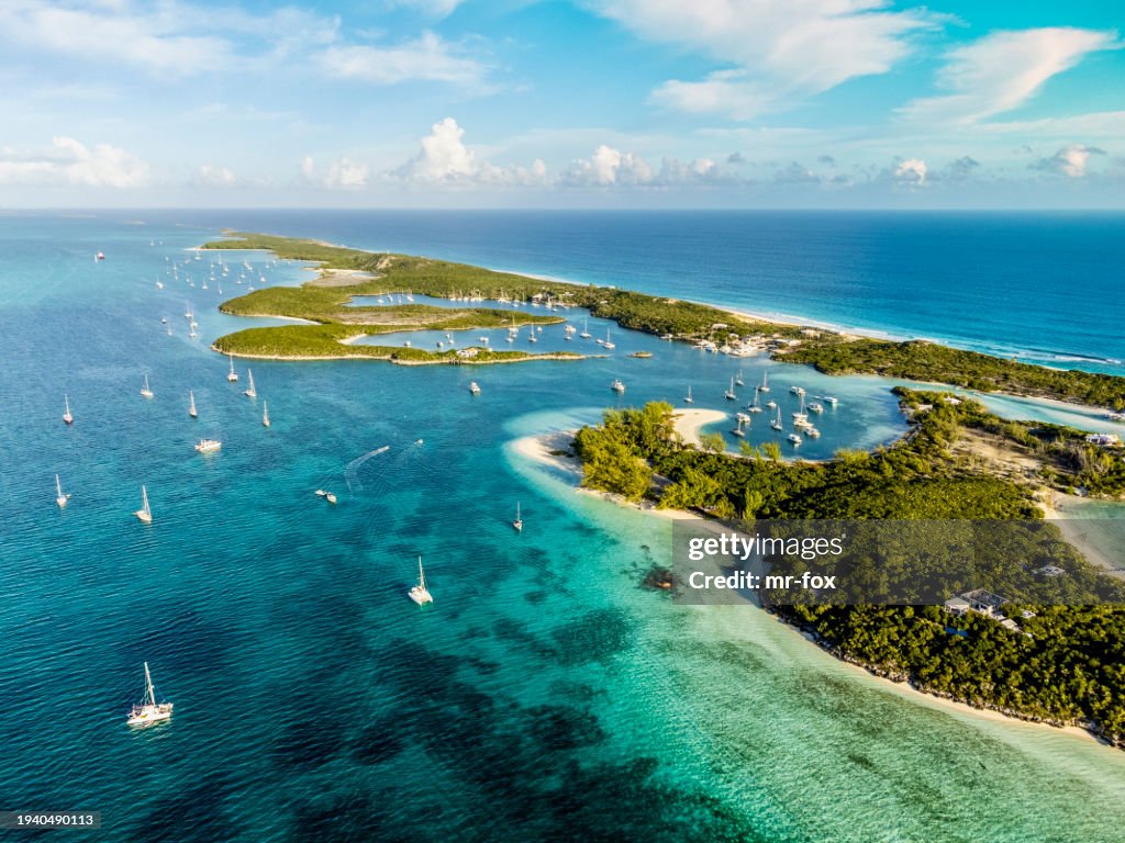 Beautiful Aerial View of Famous Chat'n'chill Conch bar in Stocking Island (Exuma - Bahamas) near George Town with many boats and Sailing Yachts Anchored