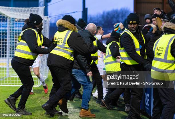 Stewards hold fans back after Stuart Bannigan scores to make it 3-0 during a Scottish Gas Scottish Cup fourth round match between Ross County and...