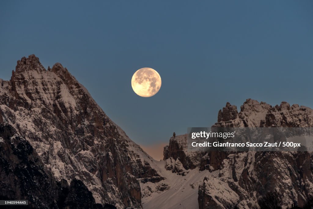 Scenic view of snowcapped mountains against clear sky at night