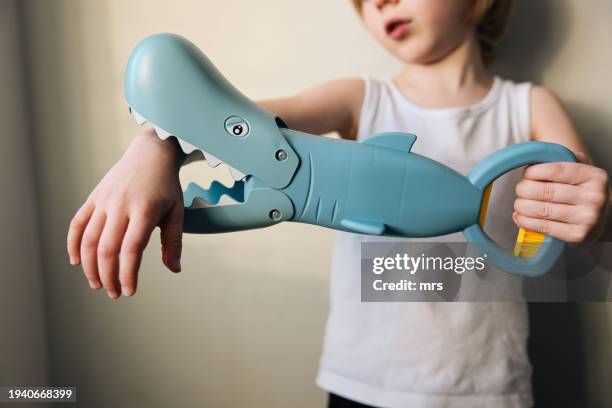 little boy playing with toy shark - plastic animals stock pictures, royalty-free photos & images