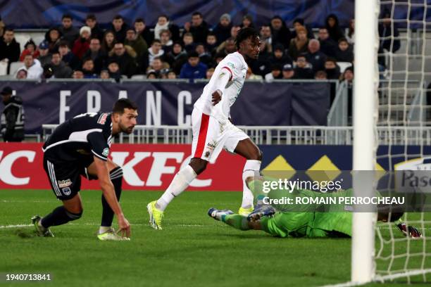 Nice' French forward Evann Guessand shoots and scores his team's first goal during the French Cup round of 32 football match between Girondins de...