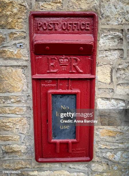 Red paint gleams on a traditional post office letter box on January 17, 2024 in Wiltshire, England. On January 10 the British Prime Minister Rishi...