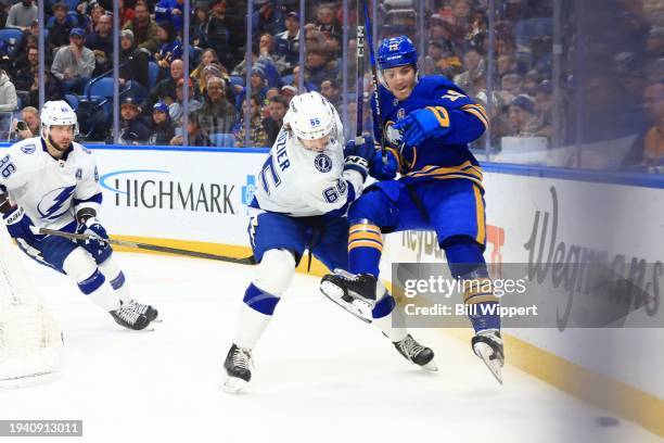 Peyton Krebs of the Buffalo Sabres battles for the puck against Maxwell Crozier during an NHL game on January 20, 2024 at KeyBank Center in Buffalo,...