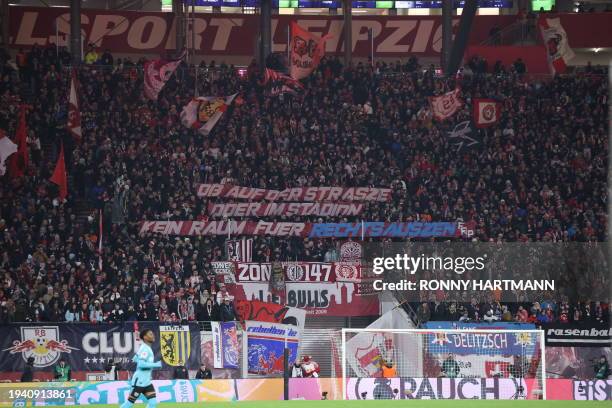 Fans cheer with a banner reading "Whether on the street or in the stadium, no room for the far right" during the German first division Bundesliga...