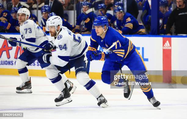 Tyler Motte of the Tampa Bay Lightning and JJ Peterka of the Buffalo Sabres skate for the puck during an NHL game on January 20, 2024 at KeyBank...