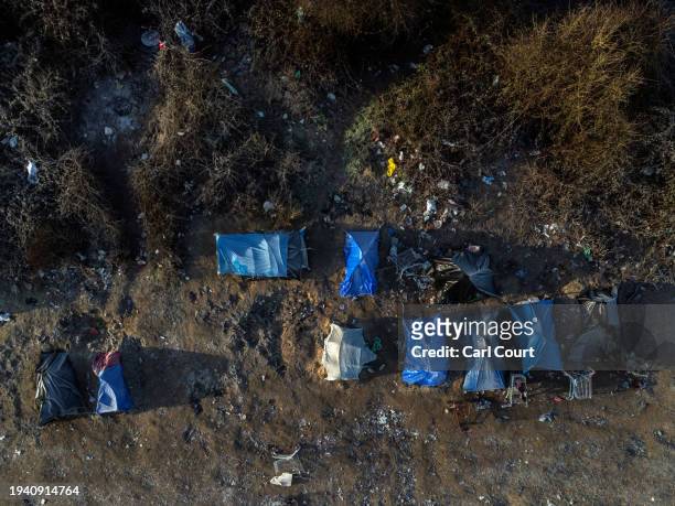 An aerial view of tents pictured in a migrant camp on January 20, 2024 in Loon-Plage, France. The first boats of 2024 carrying migrants across the...