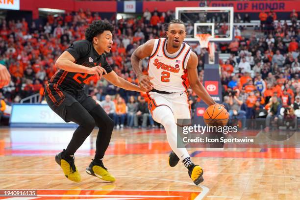 Syracuse Orange Guard JJ Starling dribbles the ball against Miami Hurricanes Guard Nijel Pack during the second half of the College Basketball game...