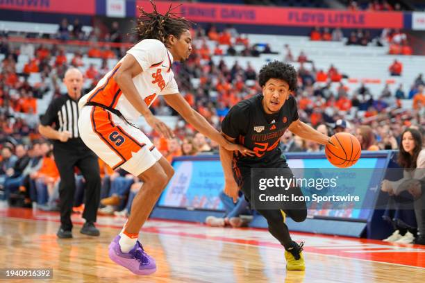 Miami Hurricanes Guard Nijel Pack dribbles the ball against Syracuse Orange Forward Chris Bell during the first half of the College Basketball game...