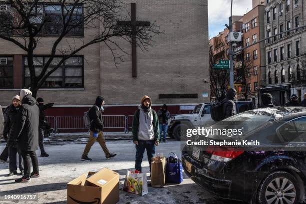 Man looks on near Tompkins Square Park as homeless migrants receive food and clothing donations on January 20, 2024 in New York City. Last month, New...