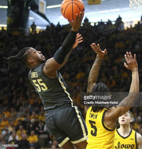 Guard Lance Jones of the Purdue Boilermakers goes to the basket during the first half against guard Dasonte Bowen of the Iowa Hawkeyes at...