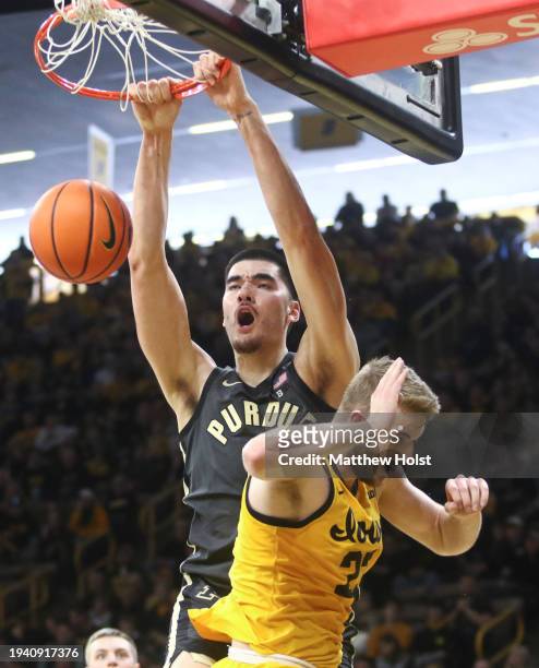 Center Zach Edey of the Purdue Boilermakers dunks the ball during the first half against forward Owen Freeman of the Iowa Hawkeyes at Carver-Hawkeye...