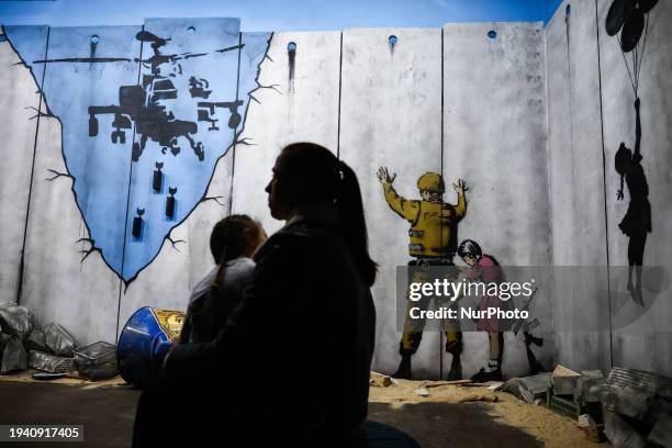 Banksy street art graffiti and murals are seen on a reconstruction of the Israeli-Palestinian separation West Bank Wall inside Banksy Museum in...