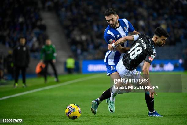 Porto's Portuguese defender Joao Mario vies with Moreirense's Portuguese defender Pedro Amador during the Portuguese League football match between FC...