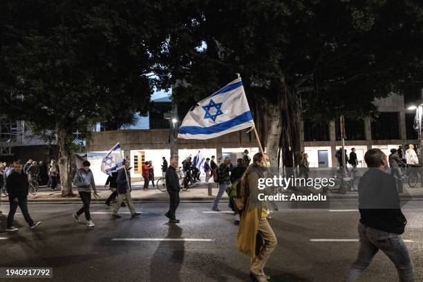 People gather to stage protest to demand the Israeli government's resignation and early elections atHabima Square, in Tel Aviv, Israel on January 20,...