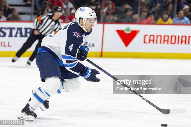 Winnipeg Jets Defenceman Neal Pionk skates with the puck during first period National Hockey League action between the Winnipeg Jets and Ottawa...