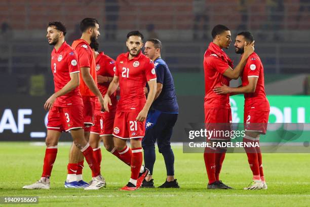 Tunisia's defender Ali Abdi and Tunisia's defender Yan Valery reacts at the end of the Africa Cup of Nations 2024 group E football match between...