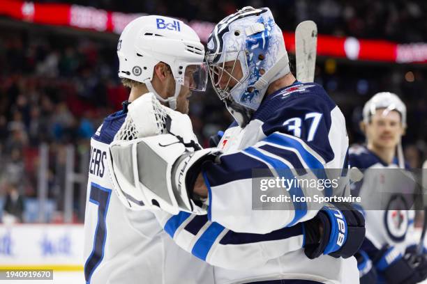 Winnipeg Jets Right Wing Nikolaj Ehlers and Winnipeg Jets Goalie Connor Hellebuyck celebrate the overtime win after Hockey League action between the...