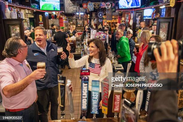 Republican presidential hopeful and former UN Ambassador Nikki Haley toasts with Guinness beer during a campaign stop at the Peddler's Daughter...