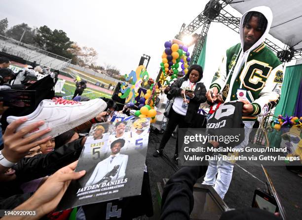 San Bernardino, CA Heisman Trophy winner and 2019 Cajon High School graduate Jayden Daniels signs autographs for fans during a homecoming ceremony...