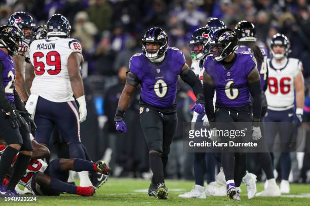 Roquan Smith and linebacker Patrick Queen of the Baltimore Ravens react during an NFL Divisional Round playoff game against the Houston Texans at M&T...