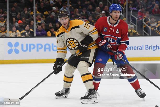 Charlie Coyle of the Boston Bruins against Mike Matheson of the Montreal Canadiens at the TD Garden on January 20, 2024 in Boston, Massachusetts.