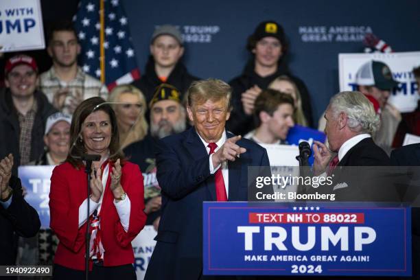 Former US President Donald Trump points at Henry McMaster, governor of South Carolina, during a campaign event in Manchester, New Hampshire, US, on...