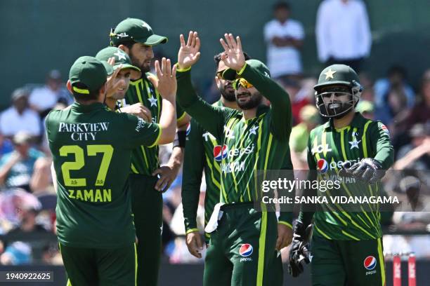 Pakistan's Sahibzada Farhan and teammates celebrate the wicket of New Zealand's Rachin Ravindra during the fifth and final Twenty20 international...