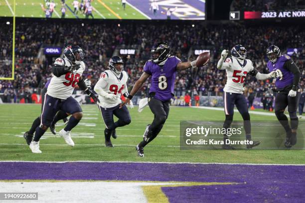 Lamar Jackson of the Baltimore Ravens scores a touchdown during an NFL Divisional Round playoff game against the Houston Texans at M&T Bank Stadium...