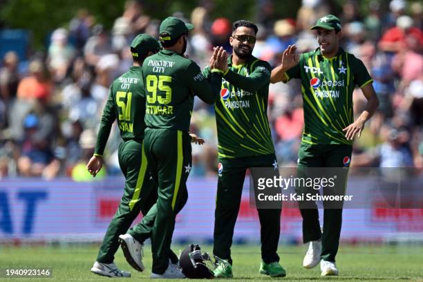 Mohammad Nawaz of Pakistan is congratulated by team mates after dismissing Will Young of New Zealand during game five of the Men's T20 International...