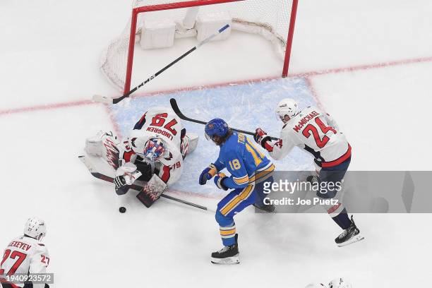 Charlie Lindgren and Connor McMichael of the Washington Capitals defend the net against Robert Thomas of the St. Louis Blues on January 20, 2024 at...