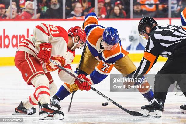 Nazem Kadri of the Calgary Flames faces-off against Ryan McLeod of the Edmonton Oilers during the first period of an NHL game at Scotiabank...