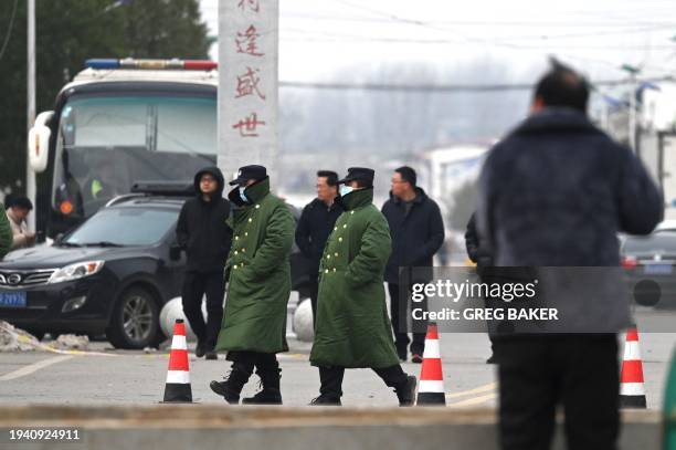 Police patrol outside Yingcai school, where 13 children died in a fire, in Yanshanpu in China's central Henan province, on January 21, 2024.