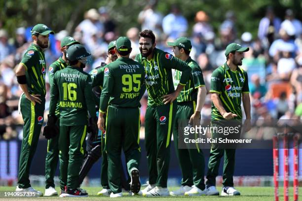 Usama Mir of Pakistan is congratulated by team mates after dismissing Mitchell Santner of New Zealand during game five of the Men's T20 International...