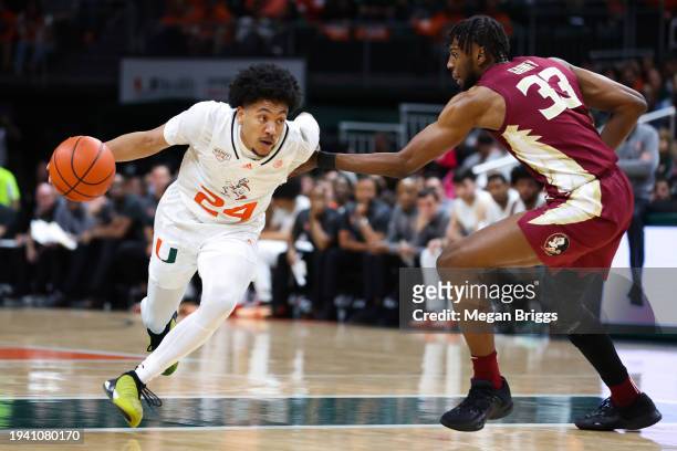 Nijel Pack of the Miami Hurricanes drives against Jaylan Gainey of the Florida State Seminoles during the first half of the game at Watsco Center on...
