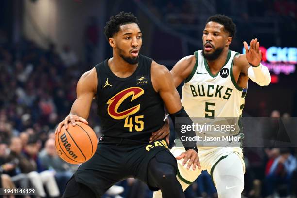 Donovan Mitchell of the Cleveland Cavaliers drives around Malik Beasley of the Milwaukee Bucks during the first half at Rocket Mortgage Fieldhouse on...