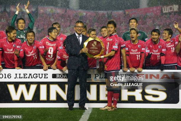 Captain Yoichiro Kakitani of Cerezo Osaka is presented the J.League J1 Promotion Play-Off Winners plaque from J.League Chairman Mitsuru Murai at the...