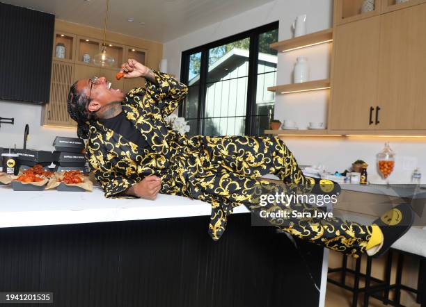 In this image released on January 18, Nick Cannon gets saucy on the set of his Buffalo Wild Wings ad shoot in Los Angeles, California.