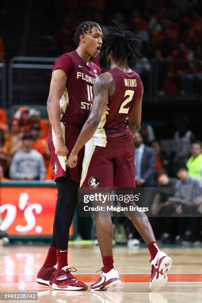 Baba Miller and Jamir Watkins of the Florida State Seminoles react on the court during the second half of the game against the Miami Hurricanes at...