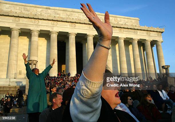 Cathy Alphin of Springfield, Virginia, worships with members of the congregation during an annual sunrise service to celebrate Easter April 20, 2003...
