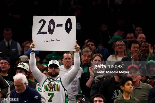 Fan holds a sign reading 20-0, the Boston Celtics home record as they are undefeated so far at TD Garden this season on January 17, 2024 in Boston,...