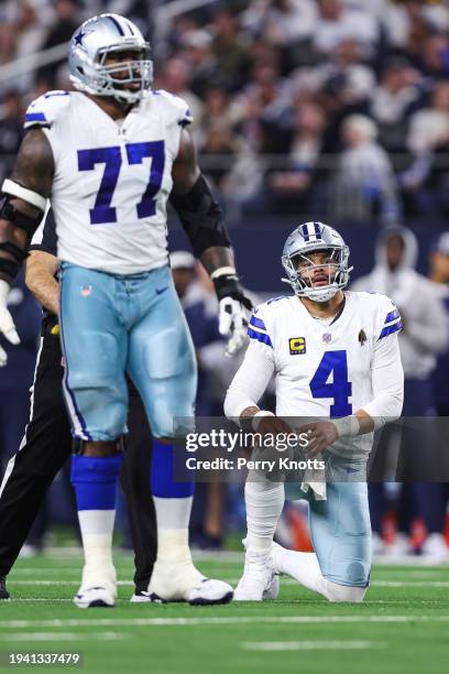 Dak Prescott of the Dallas Cowboys is slow to get up during an NFL wild-card playoff football game against the Green Bay Packers at AT&T Stadium on...