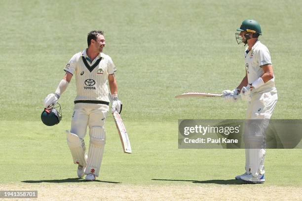 Travis Head of Australia celebrates his century with Pat Cummins during day two of the First Test in the Mens Test match series between Australia and...