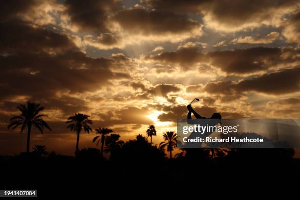 Silhouette as Tom McKibbin of Northern Ireland plays a shot on the 10th fairway during Round One of the Hero Dubai Desert Classic at Emirates Golf...