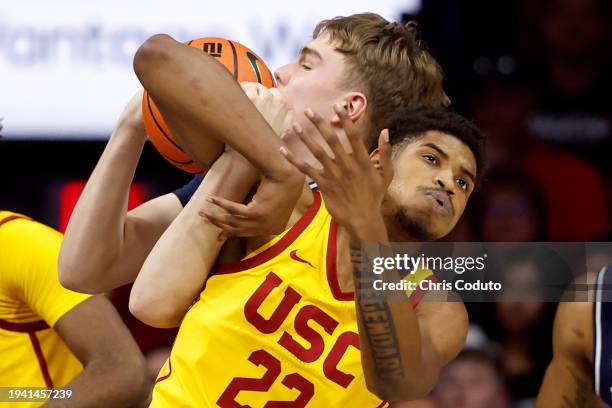 Arrinten Page of the USC Trojans and Motiejus Krivas of the Arizona Wildcats battle for a rebound during the second half at McKale Center on January...