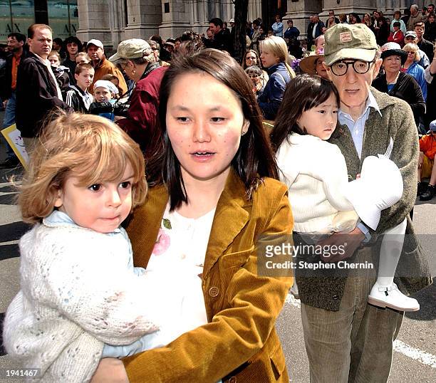 Actor and director Woody Allen walks down Fifth Avenue during the Easter Parade with his wife Soon-Yi Previn and children April 20, 2003 in New York...