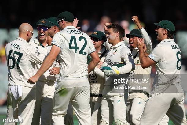 Team mates celebrate with Nathan Lyon of Australia after dismissing Justin Greaves of the West Indies during day two of the First Test in the Mens...