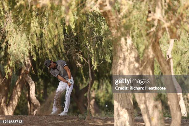 Joaquin Niemann of Chile plays from under the trees on the 13th on day one of the Hero Dubai Desert Classic at Emirates Golf Club on January 18, 2024...