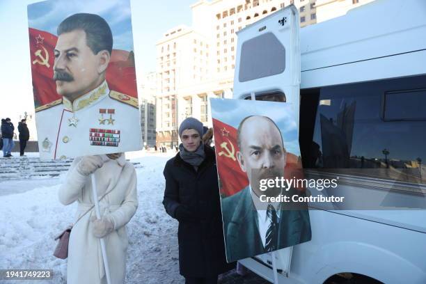 Participants hold portraits of Soviet leaders Joseph Stalin and Vladimir Lenin during the rally, hosted by the Russian Communist Party CPRF,...